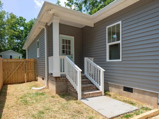 a view of a house with wooden fence
