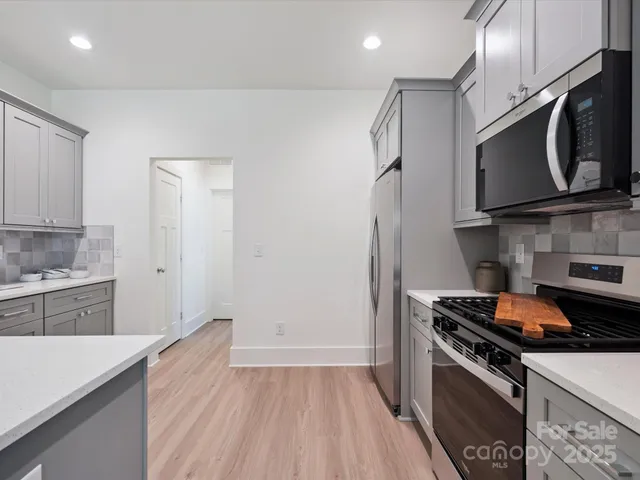 a kitchen with a sink stove and microwave