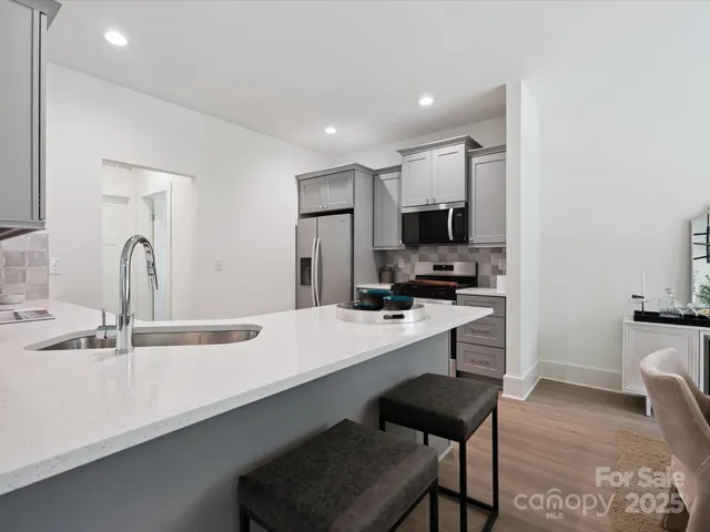a kitchen with a sink cabinets and wooden floor