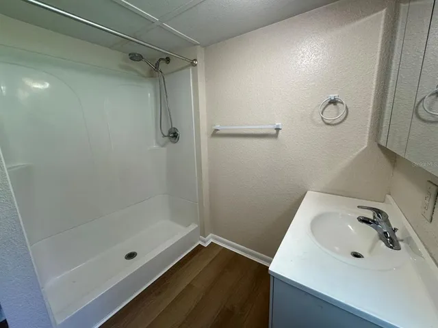 a bathroom with a sink and shower
