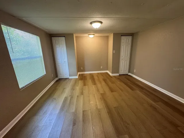 a view of wooden floor in an empty room