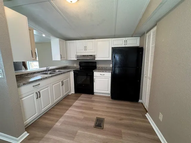 a kitchen with a refrigerator and a sink