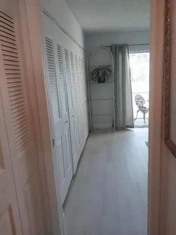 a bedroom with a bed and a potted plant