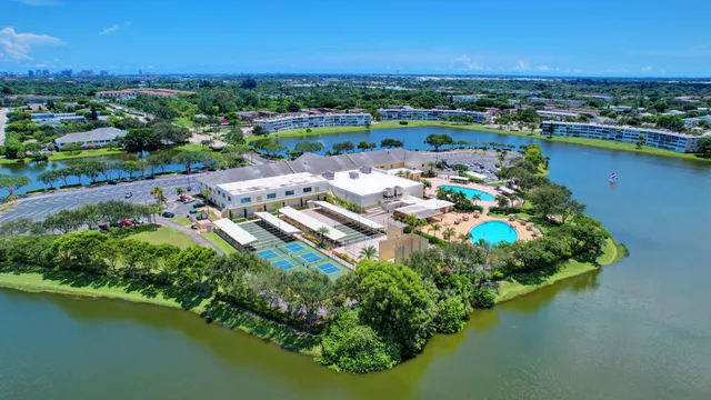 an aerial view of residential houses with outdoor space and lake view