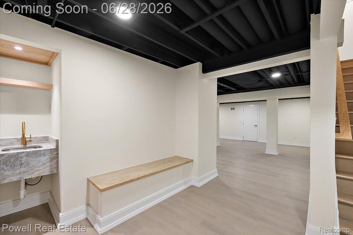 1447 Ravineview Court, Unit C12 Bloomfield Hills, MI 48304 - Photo 47 of 49 Finished lower level with light wood-finish flooring, recessed lighting, and a dark exposed ceiling