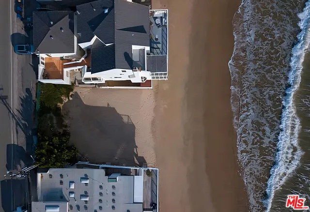 an aerial view of houses with a street