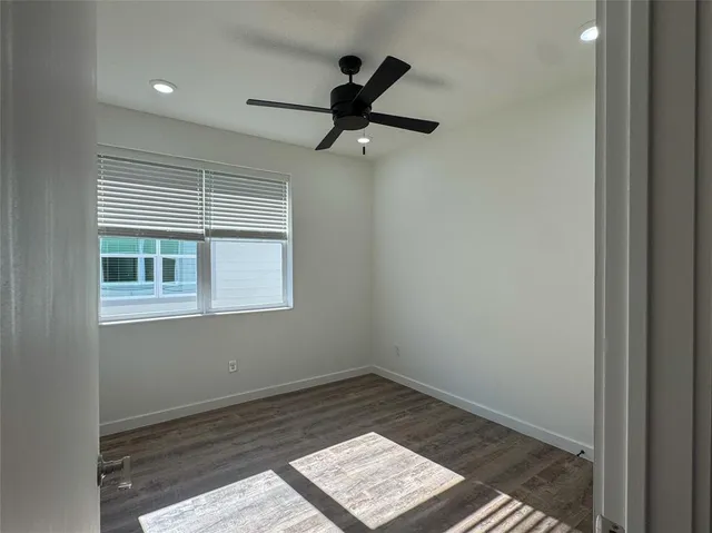 a view of an empty room and a window