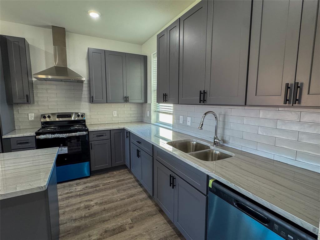 430 Lucy Road Greenville, TX 75402 - Photo 6 of 17 a kitchen with granite countertop stainless steel appliances a sink stove and refrigerator
