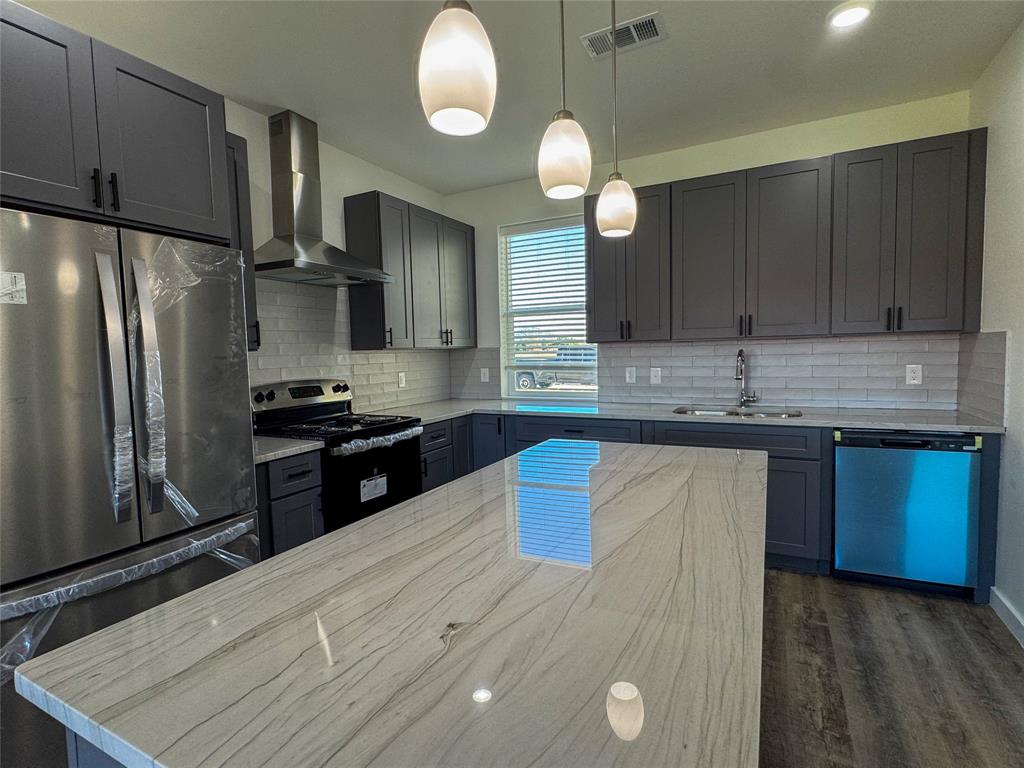 430 Lucy Road Greenville, TX 75402 - Photo 7 of 17 a kitchen with stainless steel appliances granite countertop a sink stove and refrigerator