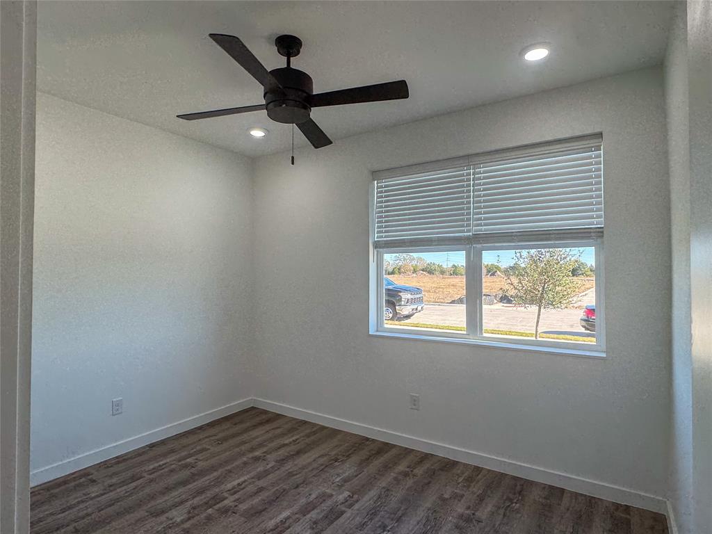 430 Lucy Road Greenville, TX 75402 - Photo 8 of 17 a view of empty room with wooden floor and fan