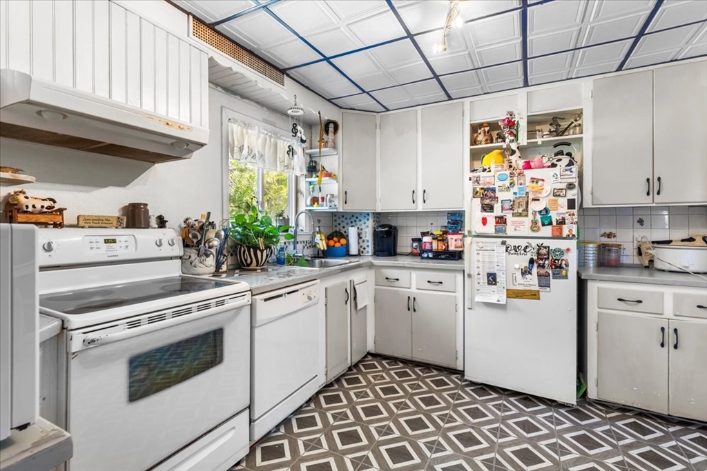 203 Pleasant Street Ashland, MA 01721 - Photo 14 of 33 a kitchen with stainless steel appliances a stove a sink and white cabinets