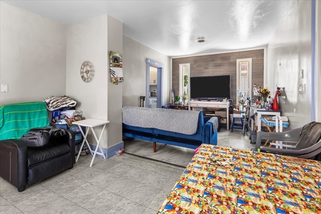 203 Pleasant Street Ashland, MA 01721 - Photo 16 of 33 a living room with furniture and a flat screen tv