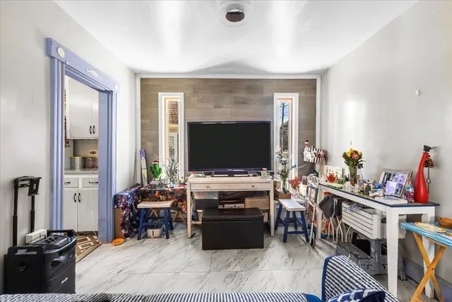 a living room with furniture and a mirror