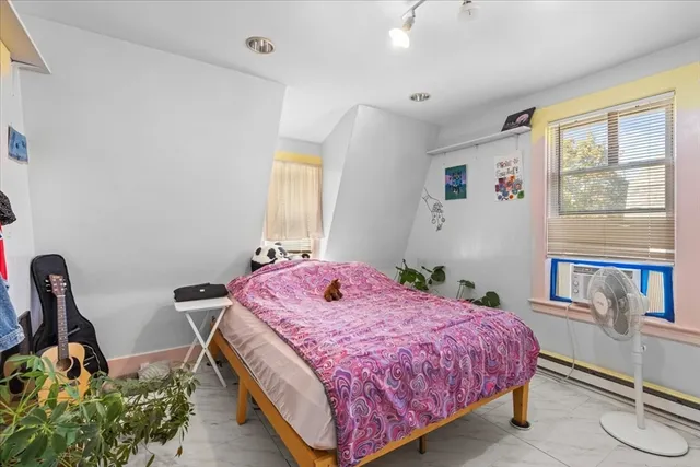 a bedroom with furniture and a window