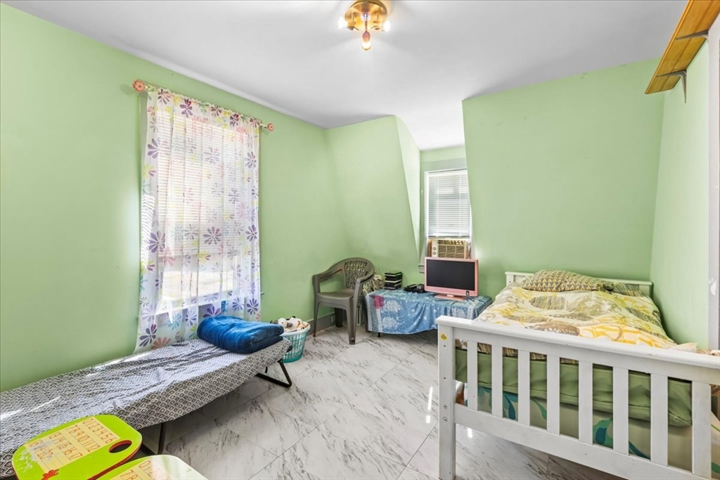 203 Pleasant Street Ashland, MA 01721 - Photo 26 of 33 a bedroom with furniture and a window