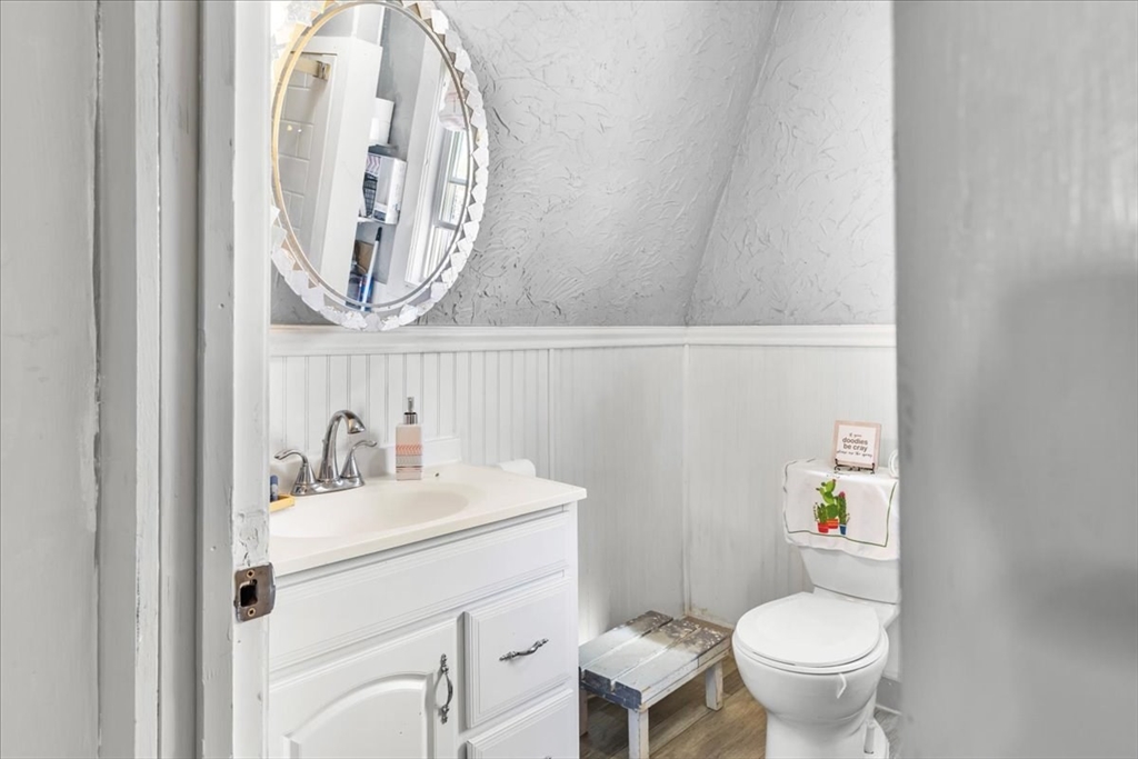 203 Pleasant Street Ashland, MA 01721 - Photo 28 of 33 a bathroom with a sink mirror vanity and toilet