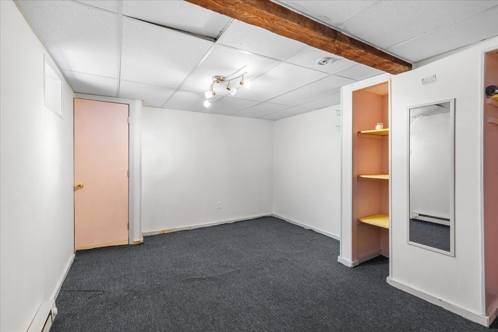203 Pleasant Street Ashland, MA 01721 - Photo 31 of 33 an empty room with chandelier fan and windows
