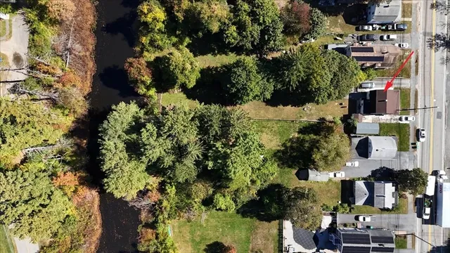 an aerial view of multi story residential apartment building with yard and parking space