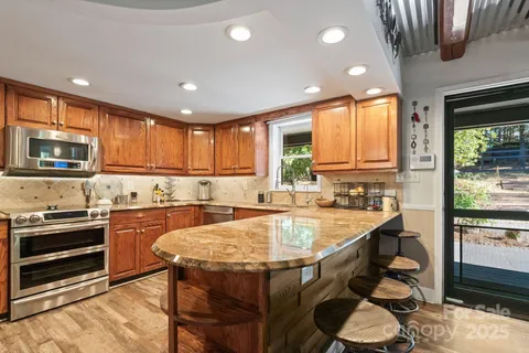 a large kitchen with lots of counter space and windows