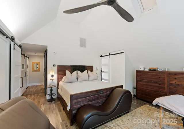 a bedroom with a bed and wooden floor