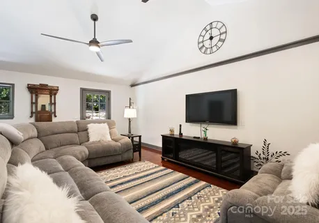 a living room with furniture and a flat screen tv