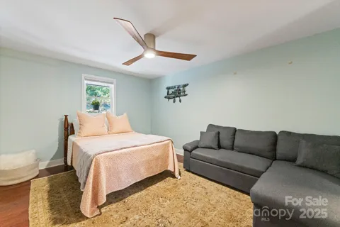 a bedroom with a bed couch and window