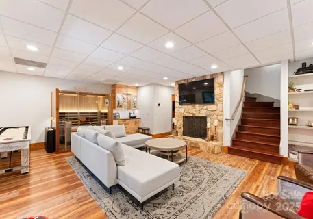 a living room with fireplace furniture and a flat screen tv