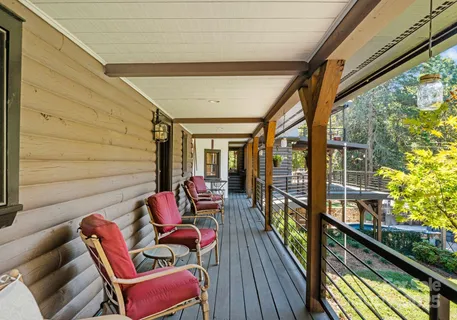 a balcony with furniture and wooden floor