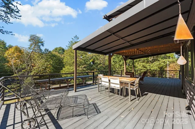 an outdoor sitting area with couch and wooden floor