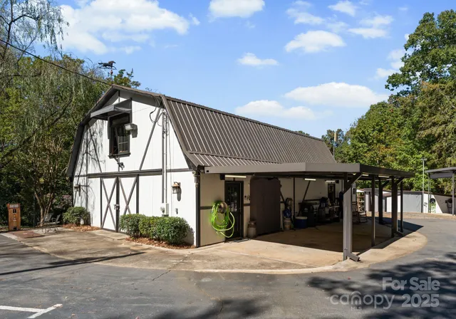 a patio with table and chairs and potted plants