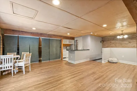 a view of a kitchen with furniture and wooden floor