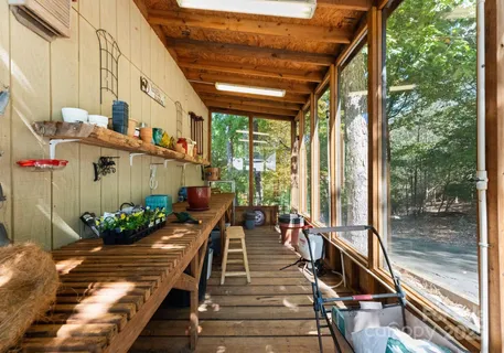 a view of a backyard with table and chairs a fire pit and large trees