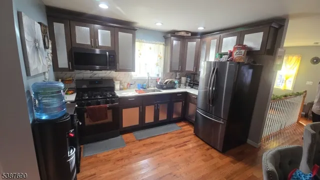 a kitchen with stainless steel appliances granite countertop a refrigerator and a stove