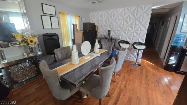 a dining room with furniture and wooden floor