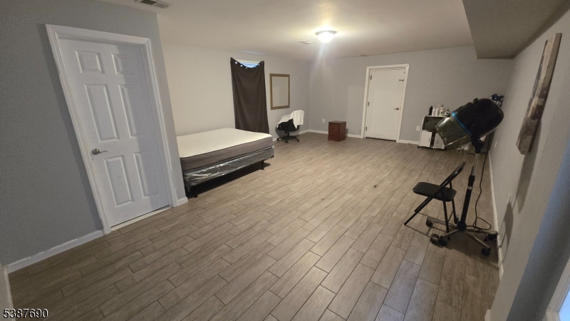 21 Rose Street Paterson, NJ 07501 - Photo 17 of 28 a view of room with wooden floor and chair