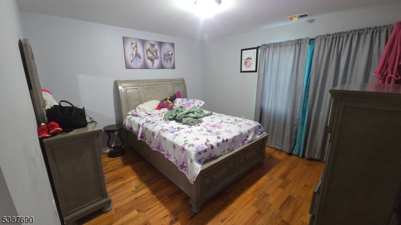 21 Rose Street Paterson, NJ 07501 - Photo 19 of 28 a bed sitting in a bedroom next to a window