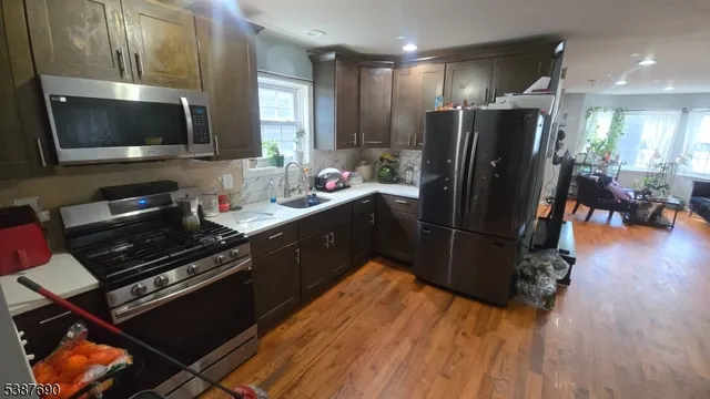 a kitchen with a refrigerator and a stove top oven