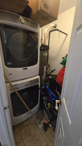 a utility room with wooden floor and washer