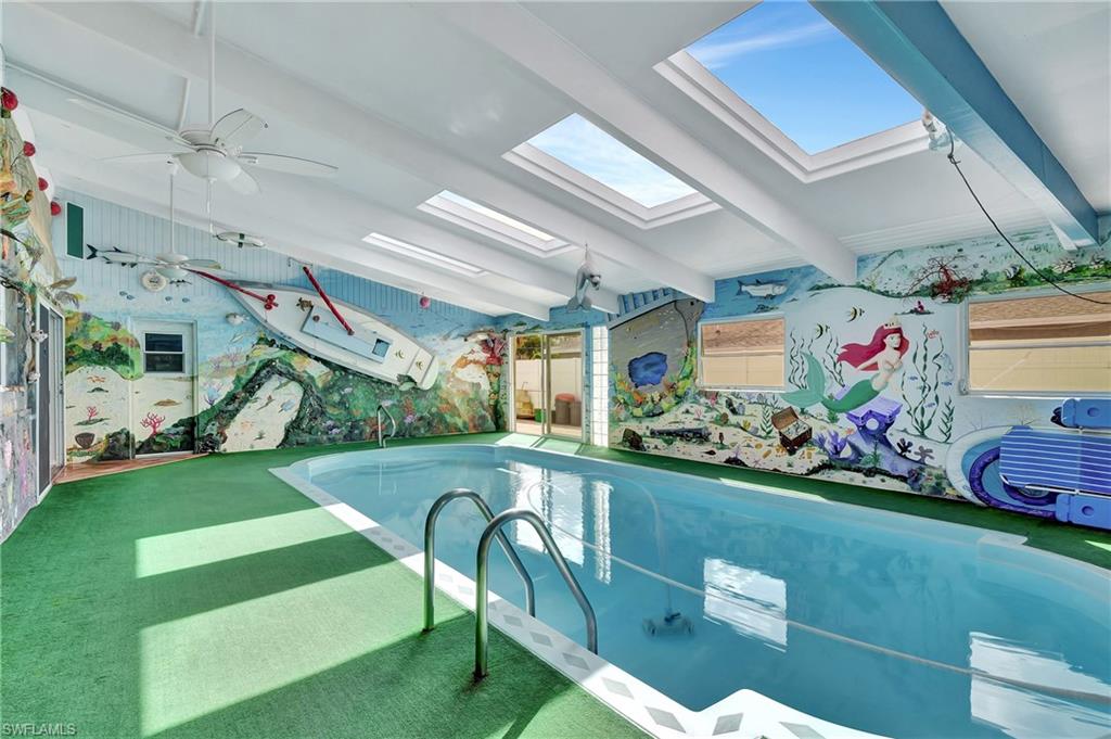 5405 Warren Street Naples, FL 34113 - Photo 1 of 37 Indoor pool with skylights and art on all four walls