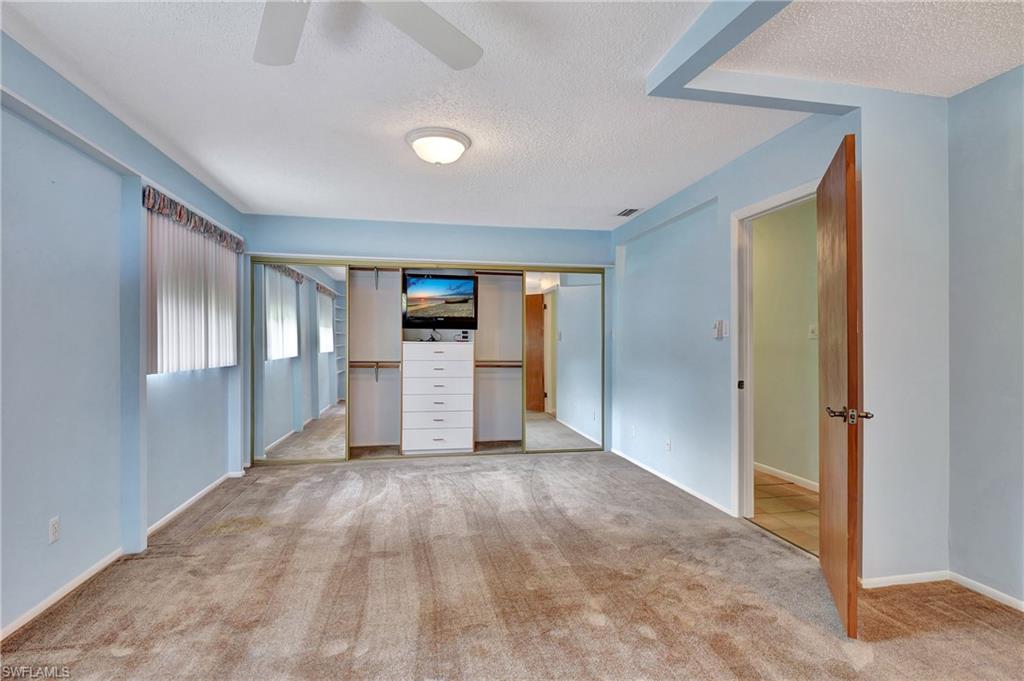 5405 Warren Street Naples, FL 34113 - Photo 21 of 37 Bedroom Closet - Hidden TV