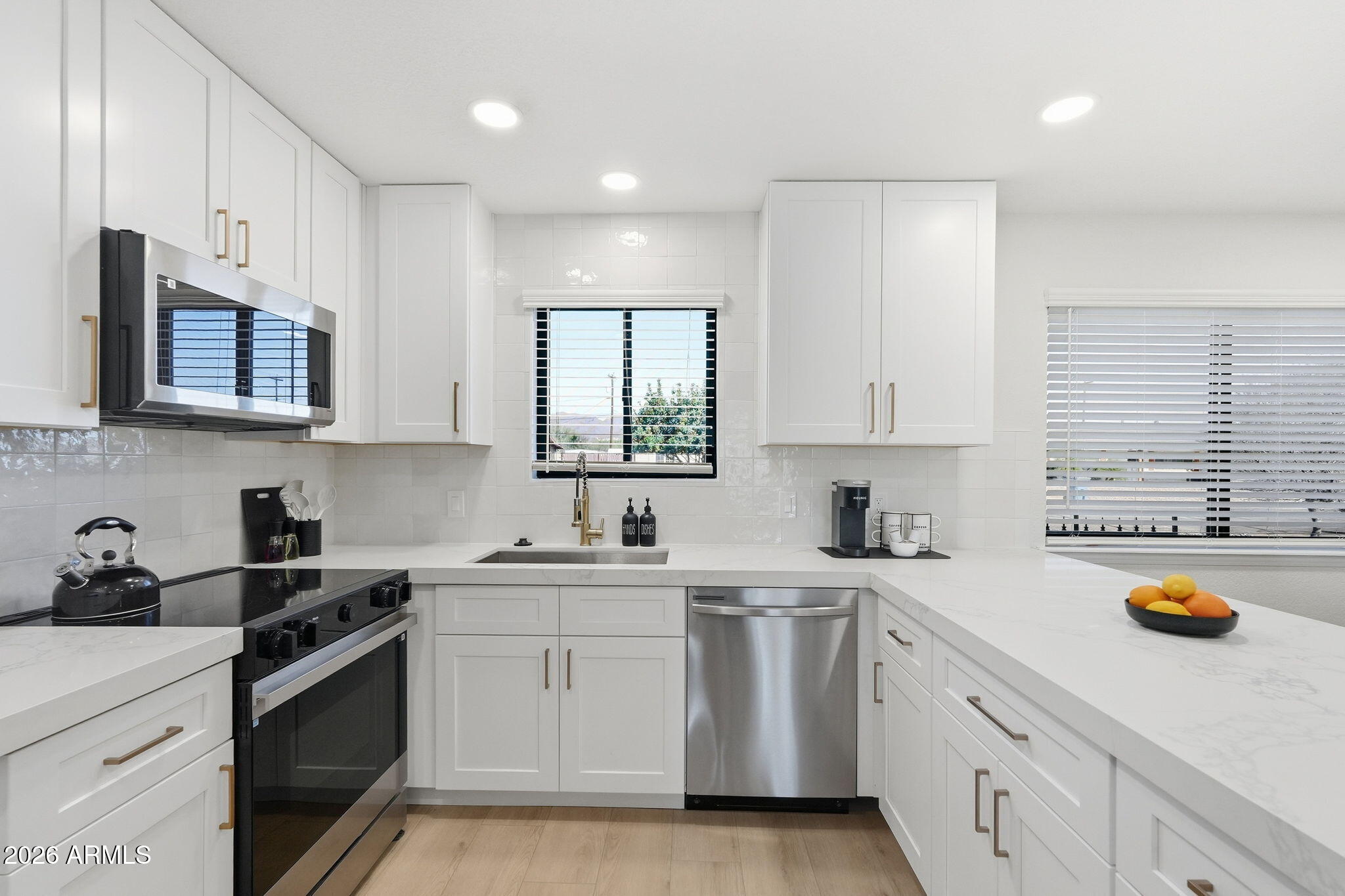 1336 South Cactus Road Apache Junction, AZ 85119 - Photo 12 of 37 a kitchen with stainless steel appliances white cabinets sink and window