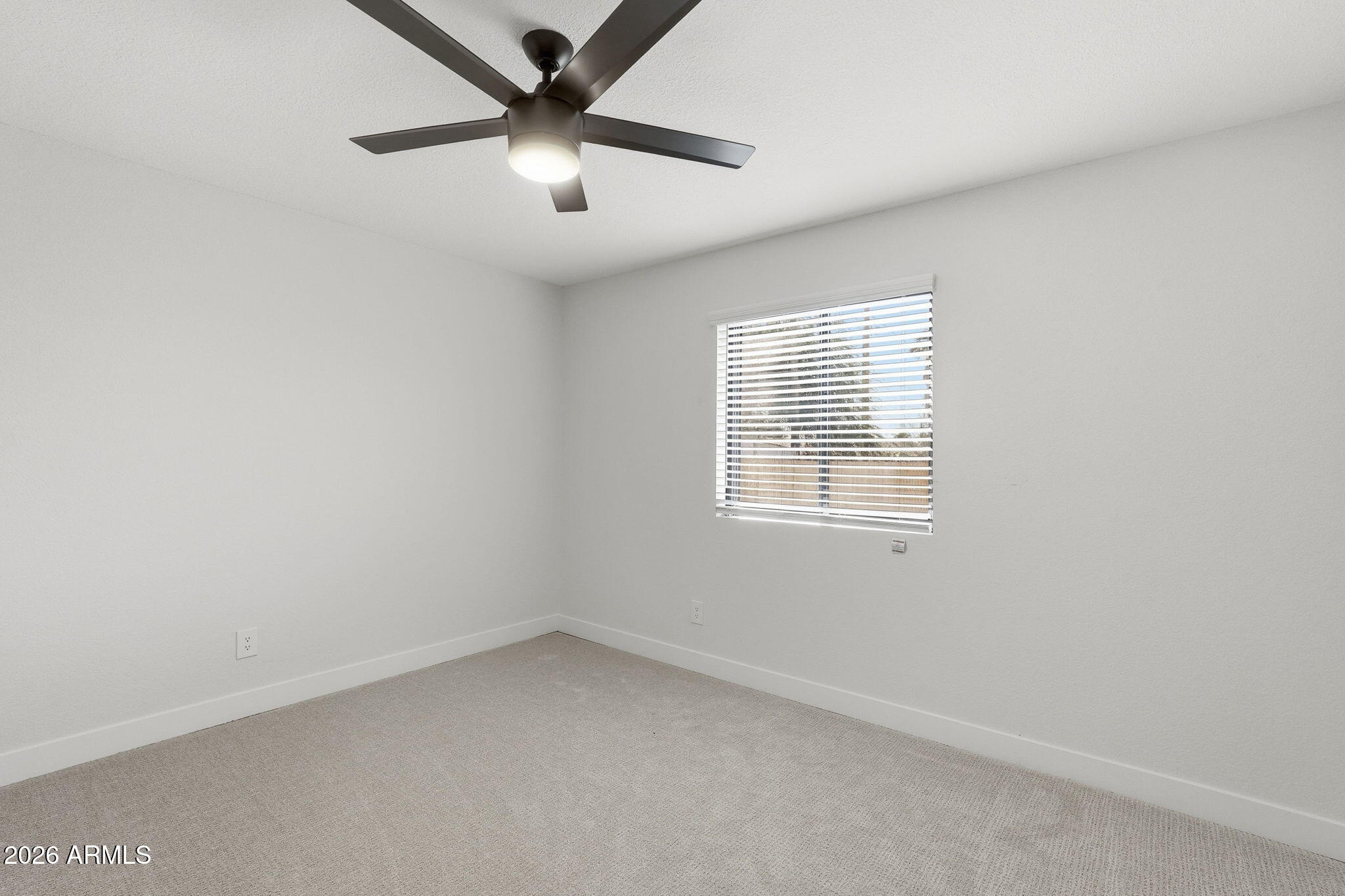 1336 South Cactus Road Apache Junction, AZ 85119 - Photo 23 of 37 an empty room with a window and a fan