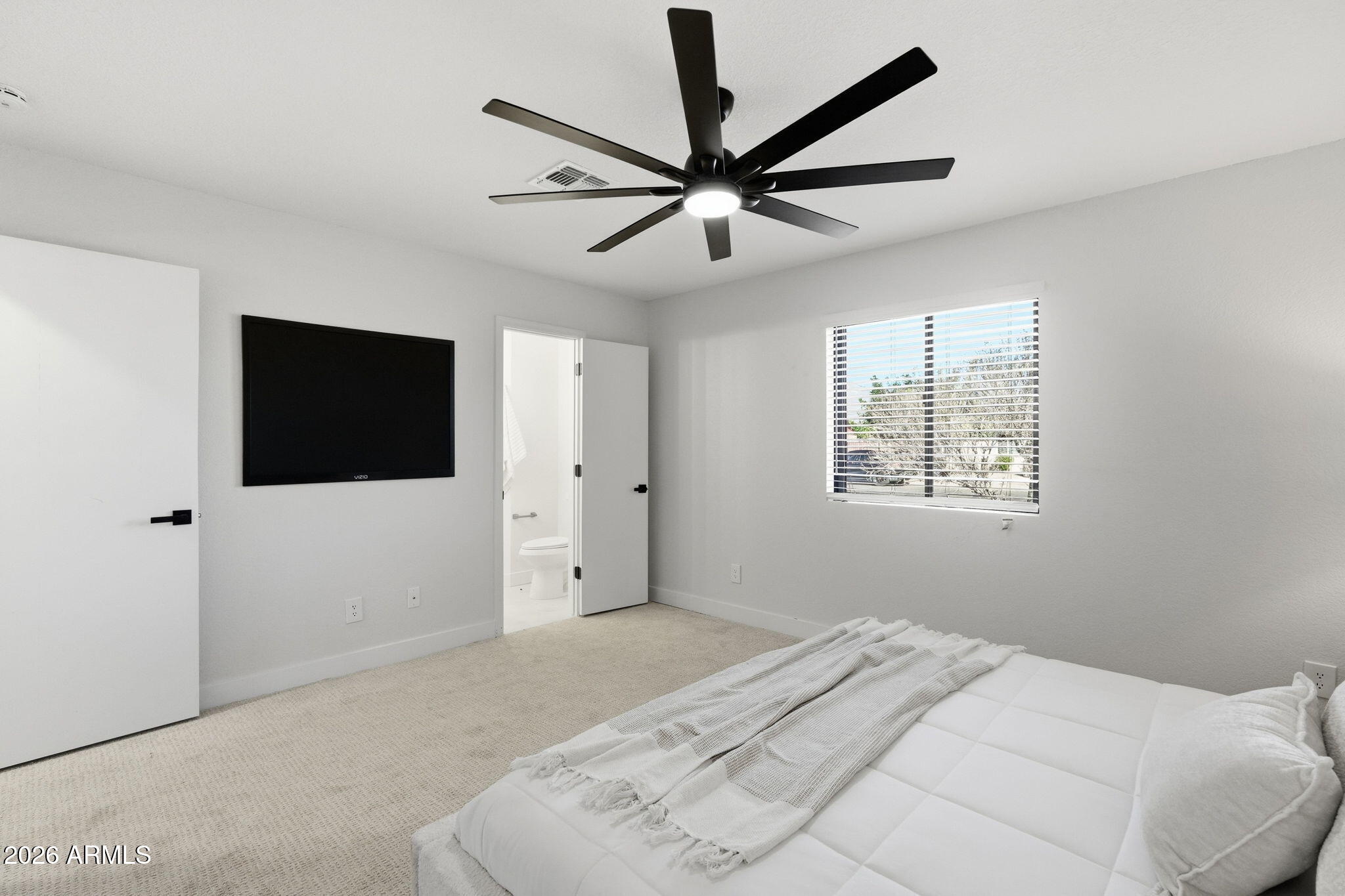 1336 South Cactus Road Apache Junction, AZ 85119 - Photo 28 of 37 a bedroom with a large bed a flat screen tv and a window
