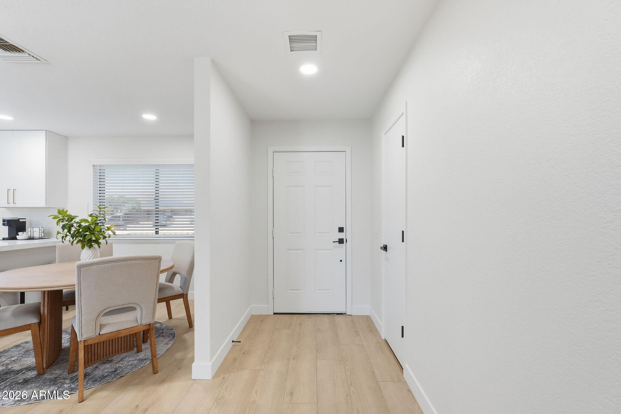 1336 South Cactus Road Apache Junction, AZ 85119 - Photo 5 of 37 a view of a hallway to dining room with furniture and wooden floor