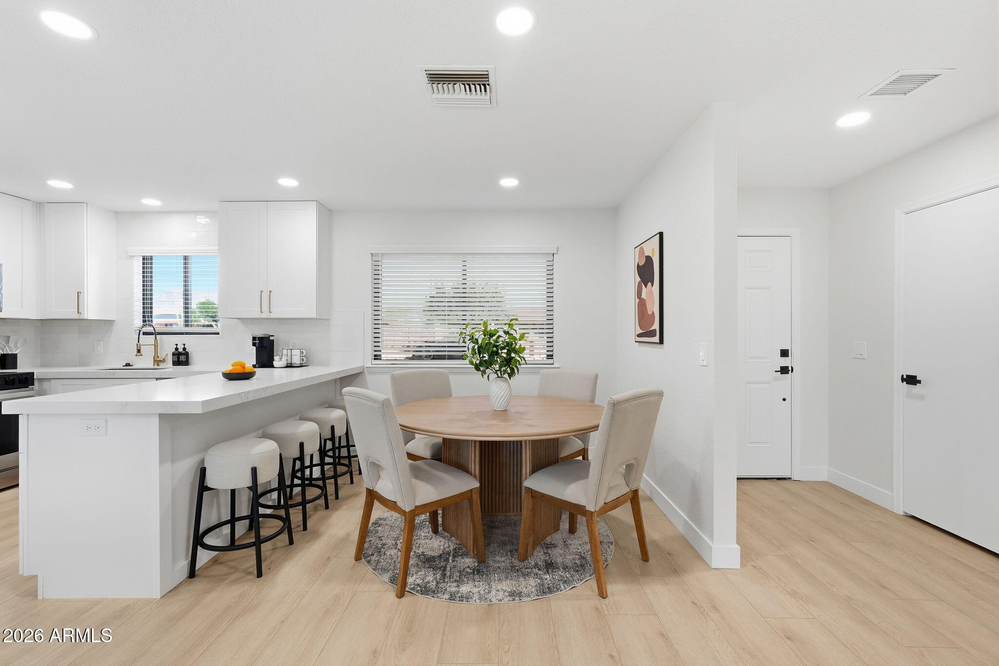 1336 South Cactus Road Apache Junction, AZ 85119 - Photo 6 of 37 a kitchen with stainless steel appliances a dining table chairs and wooden floor