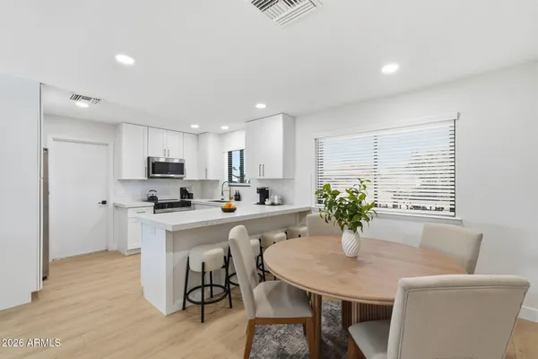 a kitchen with a table and chairs in it
