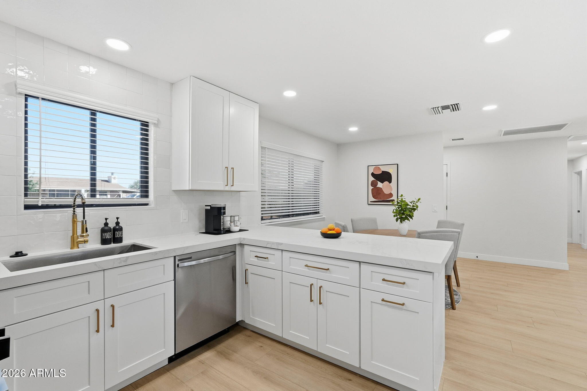 1336 South Cactus Road Apache Junction, AZ 85119 - Photo 9 of 37 a kitchen with white cabinets and sink