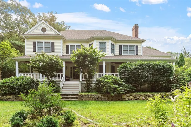 a kitchen with stainless steel appliances granite countertop dining table chairs and wooden floor