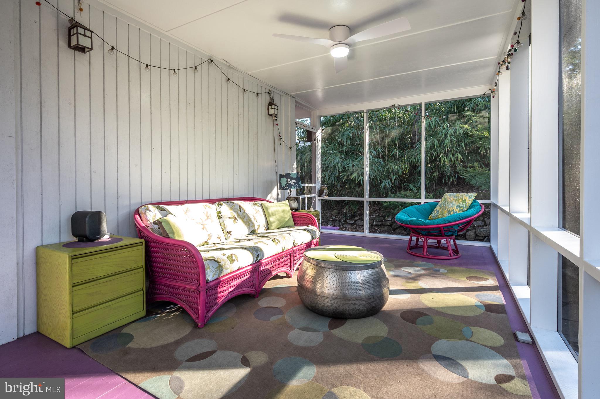 2205 Paul Spring Road Alexandria, VA 22307 - Photo 42 of 131 a living room with furniture a flat screen tv and a floor to ceiling window