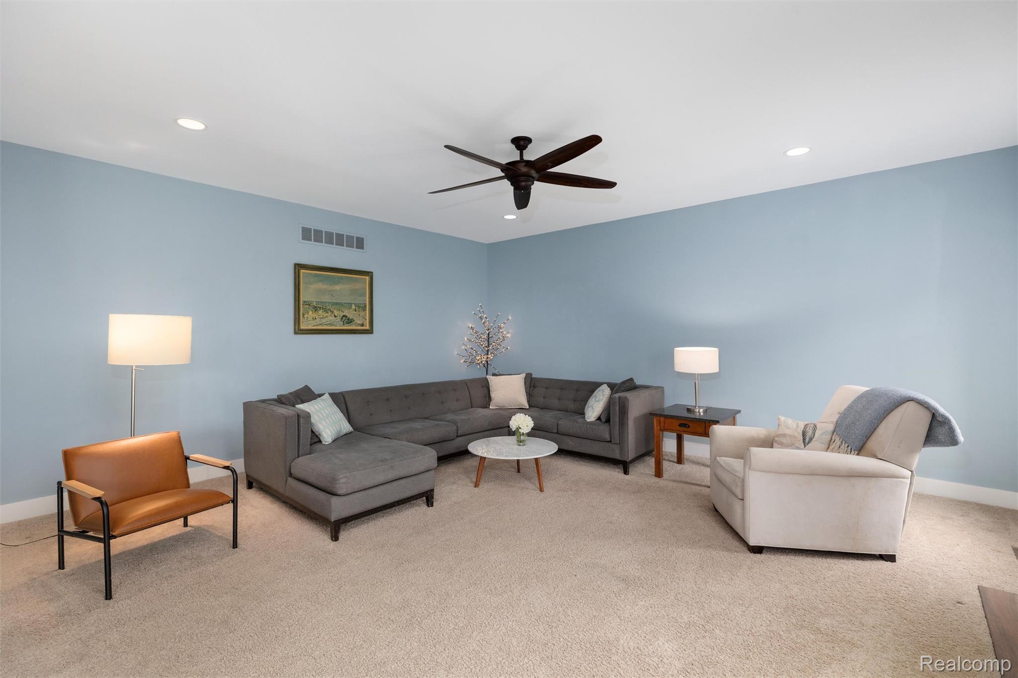 1016 West Snell Road Rochester, MI 48306 - Photo 9 of 35 Carpeted living area featuring light blue walls, recessed lighting, crown molding, and a ceiling fan